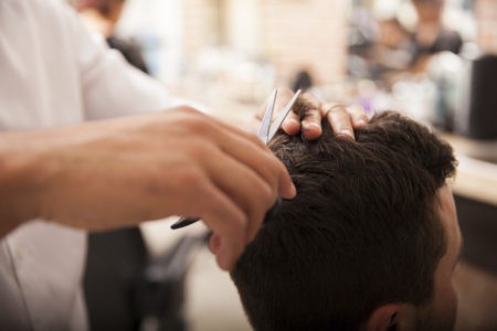 Barber cutting client's hair