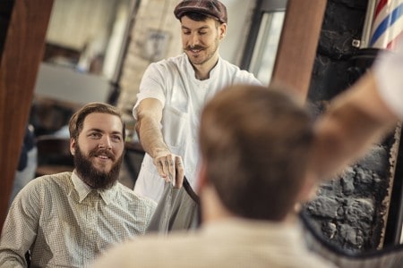 Barber giving client a hair consultation