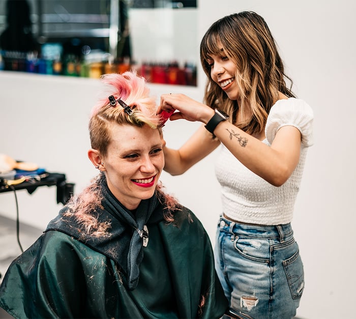 Stylist cutting client's hair